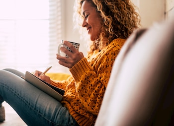 person writing in a journal